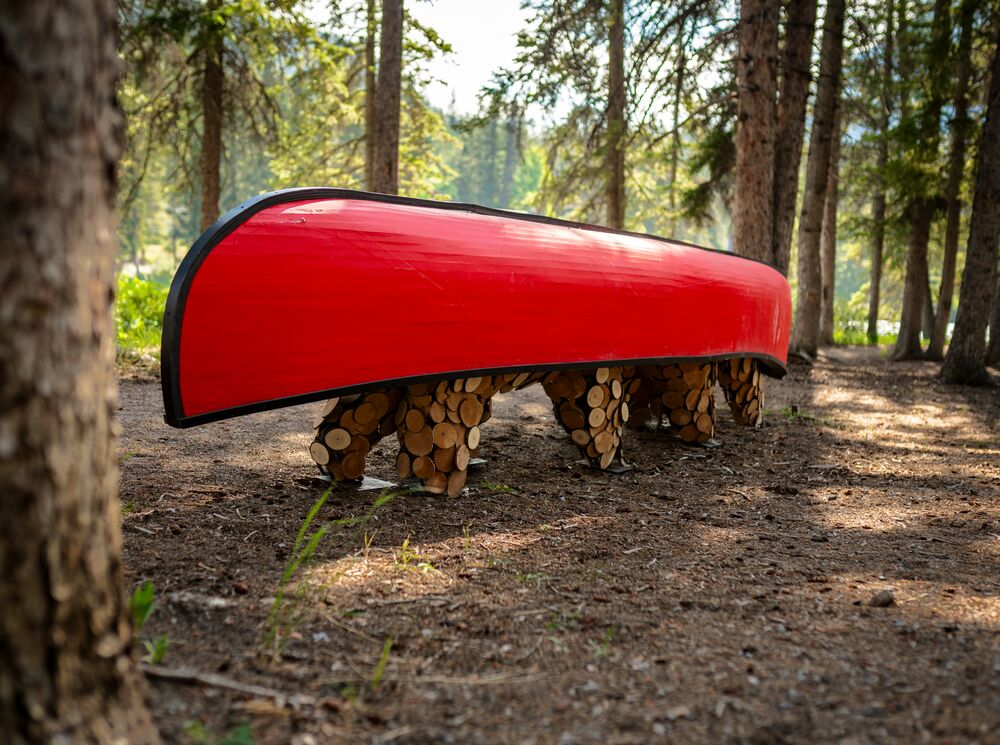 An art piece of a canoe on the back of two bears on the Art in Nature Trail in Banff National Park.